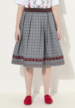 Pleated skirt in blue fabric with a floral pattern, decorative red and black waistband, and contrasting patterned lower hem.