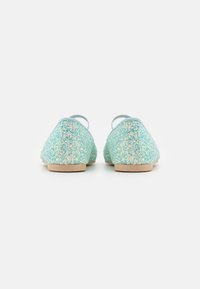 Ballerines pailletées aquatiques avec une semelle plate, un bout arrondi et deux fines brides au talon. Surface texturée avec des paillettes multicolores.