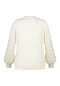 Pull en maille crème avec des motifs en forme de cœur, manches bouffantes et poignets côtelés. Texture douce, encolure ras du cou et coupe décontractée.