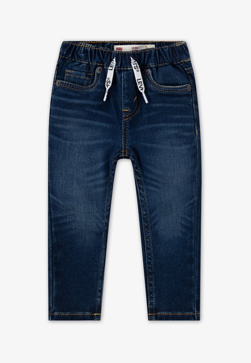 Plonos silueto džinsai tamsiai mėlynos spalvos, pagaminti iš džinso audinio, su elastinga juosmens juosta ir raišteliais. Turi penkias kišenes ir kontrastingą auksinį siuvimą.