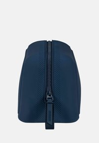 Borsa cosmetica in silicone blu navy con una texture liscia, dotata di una cerniera centrale e motivo a strisce diagonali sui lati.