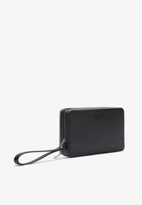 Black zippered wallet with a textured exterior, flat rectangular shape, detachable wrist strap, and subtle embossed logo detail.