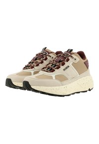 Beige and brown athletic shoes with a textured upper, chunky white speckled sole, and multicolored laces with a branded accent.