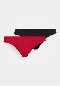 Deux culottes bikini sans couture pour femmes, une rouge et une noire, disposées à plat sur un fond blanc.