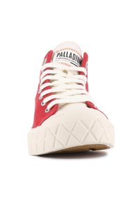 Sneaker alta in tela rossa con suola di gomma bianca, dotata di lacci bianchi e occhielli in metallo. Etichetta del marchio visibile sulla linguetta. Suola testurizzata.