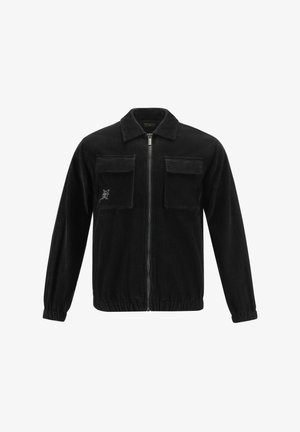 Black corduroy jacket with a zip front, two chest pockets, and elastic cuffs, featuring a subtle embroidered logo on the left pocket.