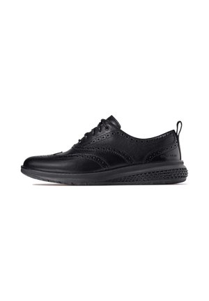Schwarze Lederschuhe mit Brogue-Detailed, runder Zehenform, Schnürdesign und einer strukturierten Gummisohle für guten Halt.