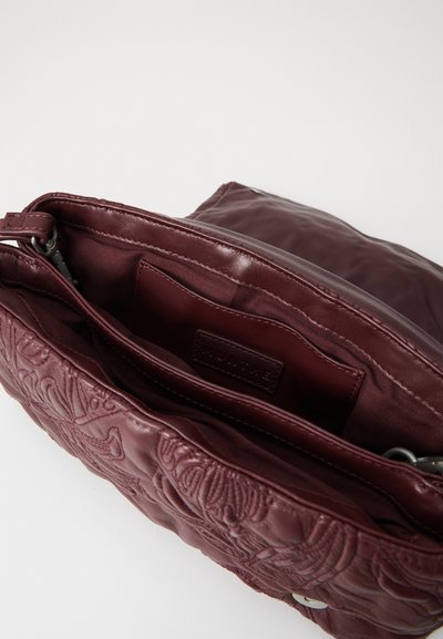 Burgundy leather bag featuring embossed floral designs, dual compartments, and a smooth interior lining. Silver hardware accents included.