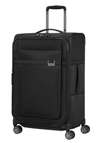 Valise noire avec un extérieur en tissu robuste, poignée télescopique, poignées sur le dessus et sur le côté, et quatre roues pivotantes pour une mobilité facile.