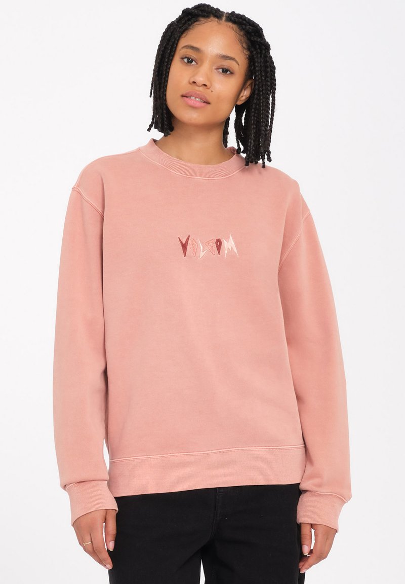 Rosa Sweatshirt mit gerippten Bündchen und Saum, versehen mit einem stilisierten "Volcom"-Logo in kontrastierenden Farben auf der Brust. Hergestellt aus weichem Stoff.