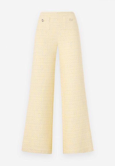 Wide-leg trousers in textured yellow fabric. Features two front pockets and metallic button accents. Clean, minimalist design.