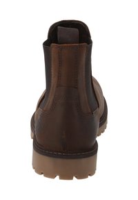Bottes chelsea en cuir marron avec des panneaux latéraux élastiques, un renfort à l'arrière, et une semelle en caoutchouc avec des crampons pour une meilleure adhérence et durabilité.