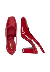 Karmiinpunased läikivad nahast kõrged kontsad ruudukujulise varbaga ja avatud kanna disainiga. Omab paksu kontsa ja peent logo kinga sees.