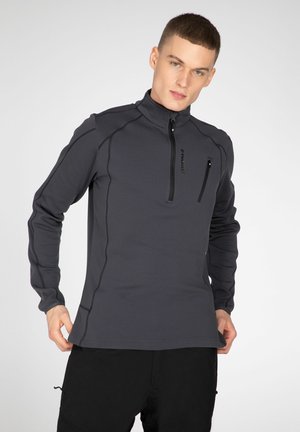 Grijze langemouwen pullover met een halve rits aan de voorkant, een fitted design, naaddetails en een ritszak op de borst. Gemaakt van textuurstof.