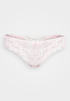 Pink lace thong featuring floral patterns, a scalloped edge, a small central bow, and decorative chain accents with pearl details.