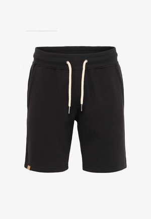 Mustad musta sportlikud lühikesed püksid, mis on valmistatud pehmest puuvillasegust riidest. Omavad elastset vöökohta koos reguleeritavate kreemjate nööpidega ja dekoratiivsete külgõmblustega.