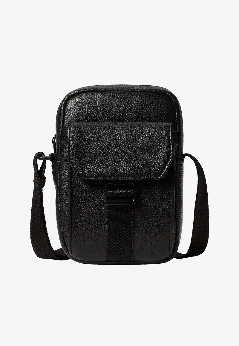 Συμπαγές μαύρο τσαντάκι ώμου από δερμάτινη υφή με μπροστινή τσέπη με καπάκι και ρυθμιζόμενο υφασμάτινο λουράκι.