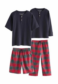 Navy short-sleeve henley shirts with button accents, paired with red plaid pajama shorts and long pants featuring green and black stripes.