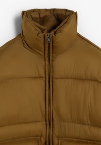 Geacă puf maro cu guler înalt și fermoar frontal. Fabricată din material sintetic, cu o textură netedă, matlasată și cusături orizontale.