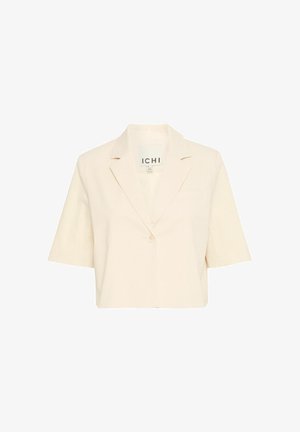 Blazer court à manches courtes, de couleur beige clair, en tissu texturé, avec des revers crantés, une fermeture à un bouton et une poche poitrine gauche.