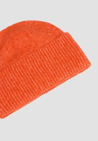 Orange knit beanie hat with a ribbed cuff. Made from soft, textured fabric, featuring a rounded crown and vibrant color.