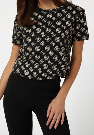 Sort T-shirt med korte ærmer, der har et gentaget creme-logo mønster med metalliske detaljer. Glat stof med en afslappet pasform.