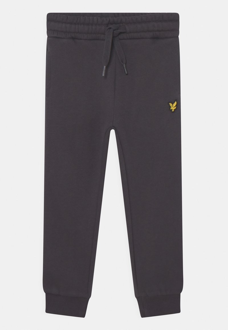 Mørkegrå sweatpants lavet af blødt materiale, med elastisk talje og snøre, ribbede mansjetter og et lille gult logo på siden.
