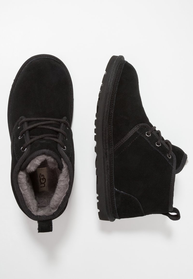 Black suede ankle boots with lace-up design, soft fleece lining, and a textured rubber sole. Features a rear pull tab for easy wearing.