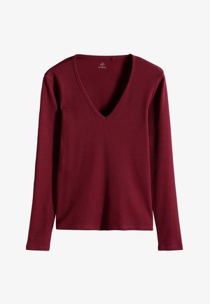 Top lungo bordeaux a maniche lunghe con texture a coste e scollatura a V profonda. Presenta uno stile semplice e privo di decorazioni.