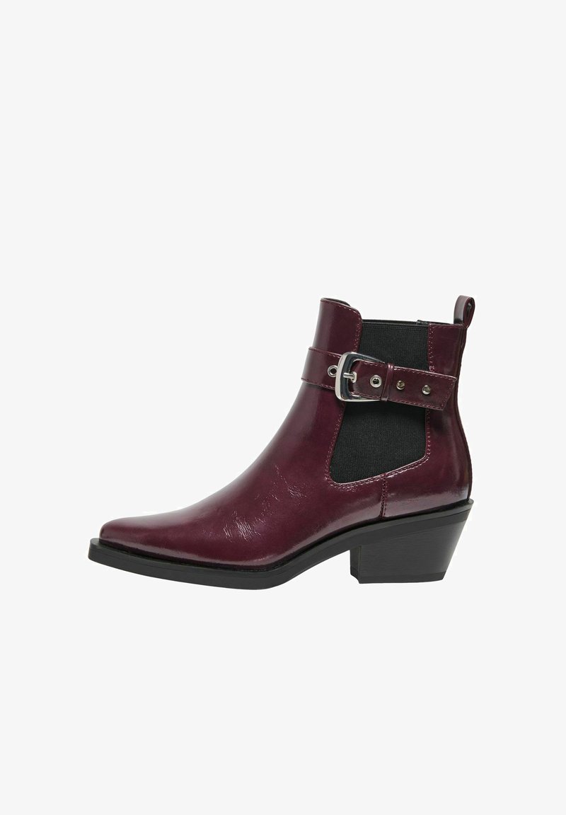 Botín burdeos con un acabado brillante, panel elástico lateral, detalle de hebilla y forma ligeramente afinada. Cuenta con un bajo tacón rectangular.
