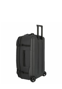 Valise noire à roulettes en matériau rigide durable, fermeture à double zip, poignée extensible et quatre roues multidirectionnelles.