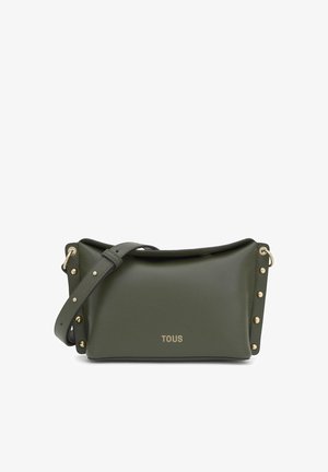 Bolso de hombro de cuero verde oliva con tachuelas doradas y correa ajustable, con el logo "TOUS" en dorado en el centro del frente.
