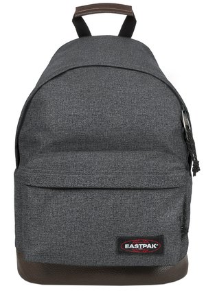 Gray fabric backpack with a rounded shape, brown leather bottom, front pocket, and top handle. Features a logo patch on the lower front.