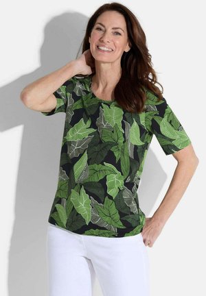 Chemise à manches courtes avec un fond noir et des motifs de feuilles vert vif. Conçue en tissu léger, avec un col rond et une coupe décontractée.