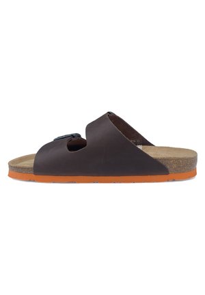 Brown leather slide sandal with open toes, featuring a black adjustable buckle and a cork footbed; orange rubber outsole provides grip.