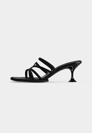 Black strappy mule sandal with four thin straps and a flared kitten heel on a plain light background.