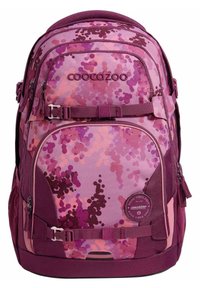 Purple and pink camouflage backpack with multiple compartments, adjustable straps, and a round logo patch. Made from durable fabric.