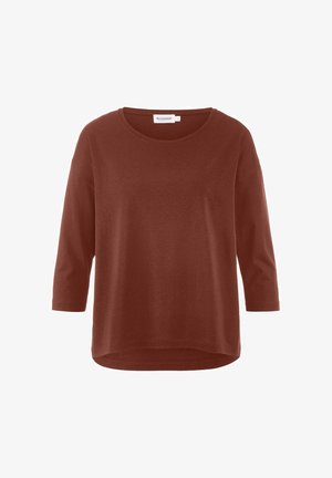 Rostfarbenes Langarmoberteil mit rundem Ausschnitt, lockerer Passform und leichtem, geschwungenem Saum. Weicher Stoff und minimale Details.