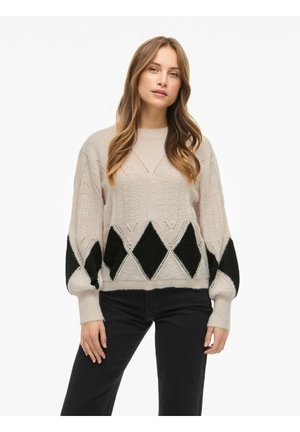 Kreminė megztinė su juodais rombų raštais. Turi ilgomis rankovėmis ir pakeltomis rankogaliais, tekstūruotas audinys. Stilius - laisvas ir patogus.