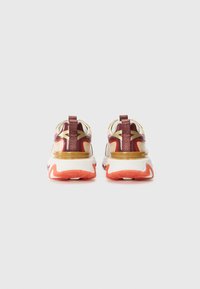 Sport shoes with a multicolored upper in red, beige, and gold, featuring a padded collar, pull tab, and textured sole in orange and white.
