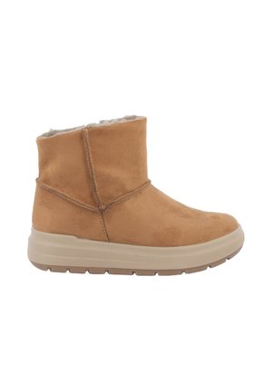 Stivaletti alla caviglia in suede beige con rivestimento morbido, un semplice design cucito e una spessa suola beige. Dettaglio della cucitura laterale è visibile.
