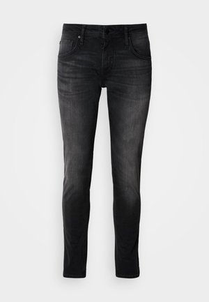 Black denim jeans with a slim fit, five-pocket design, subtle fade, and contrast stitching. Features classic metal button and zipper closure.