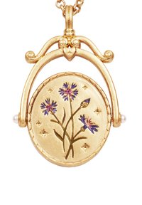 Gold-tone floral locket pendant features hand-painted purple flowers, set against a textured circular background surrounded by small stars.