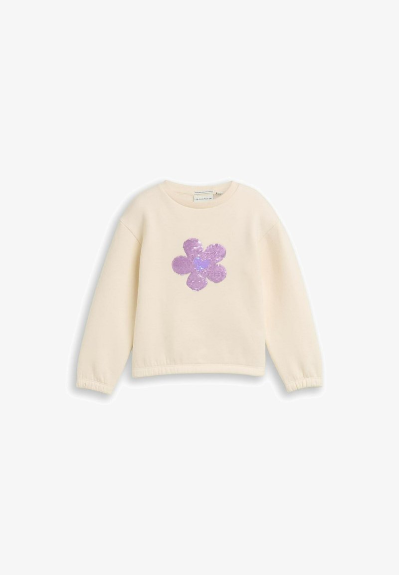 Felpa leggera color crema con maniche lunghe, caratterizzata da un design a fiore di paillettes viola sul davanti e polsini arricciati all'orlo.