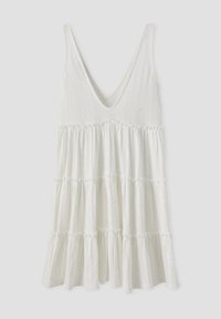 Robe blanche sans manches avec un décolleté en V, des volants étagés et un motif ajouré. Texture douce avec une silhouette fluide.