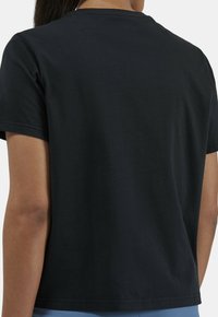 Black cotton t-shirt with a classic round neck and short sleeves. Smooth texture, simple design, no visible patterns or accents.