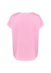 Blusa de manga corta de corte holgado en tela rosa clara, con un escote redondo y un dobladillo ligeramente curvado. Textura suave y ligera.