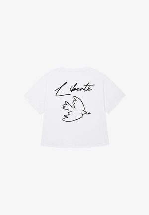 White t-shirt featuring a black line drawing of a dove holding an olive branch, with the word "Liberté" written above it in cursive.