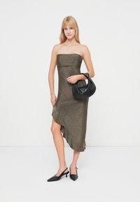 Bezlaukė bronzinė suknelė su prigludusia liemene ir asimetrišku apvadu. Pora su juodu hobo krepšiu ir juodais slingback aukštu kulnu.