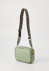 Green textured leather crossbody bag with a rectangular shape, gold hardware, and a patterned adjustable strap featuring brown accents.